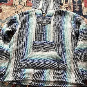 A white teal, blue, black and gray light jacket